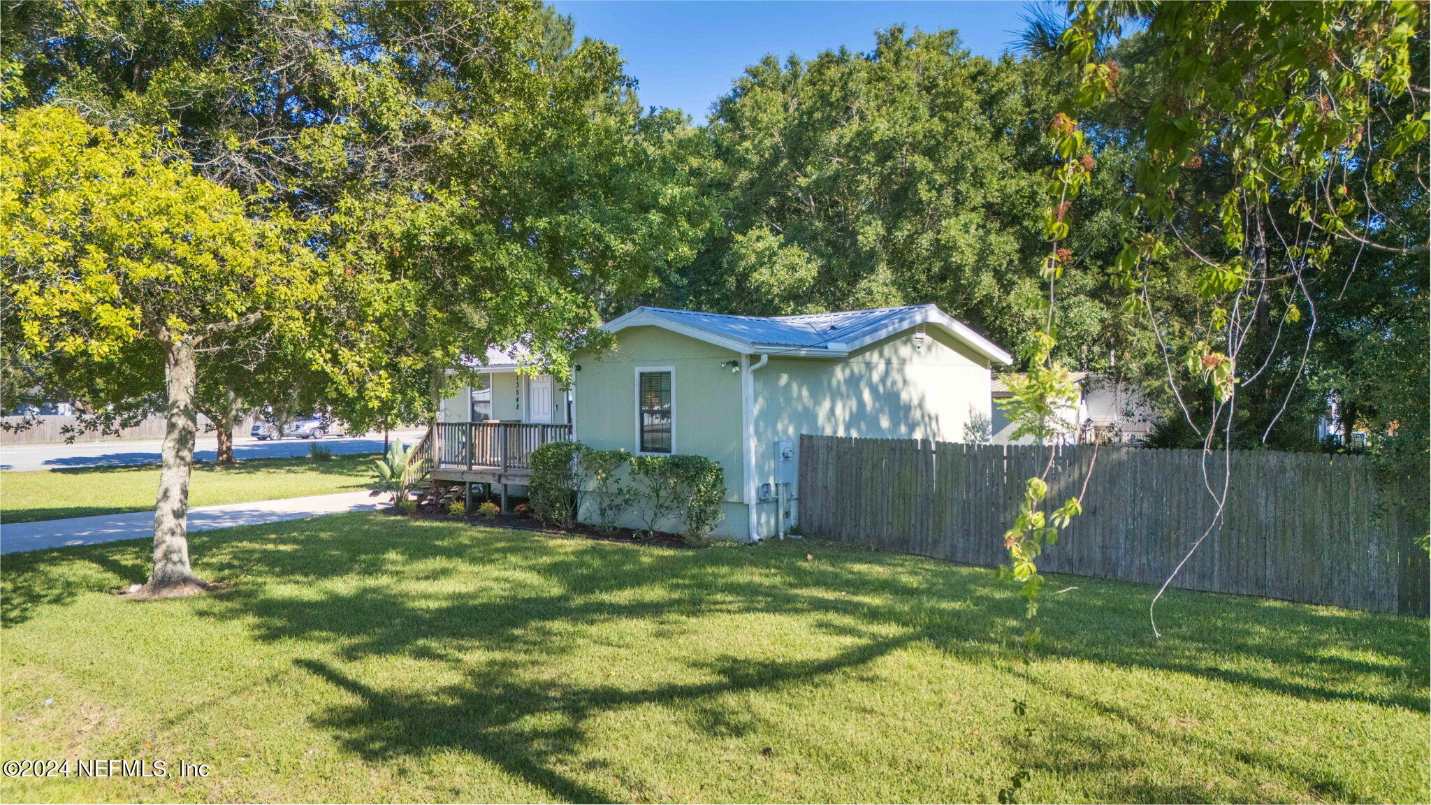 13548 Chauny Road Jacksonville, FL 32246 - Photo 39 of 55 a view of a house with a yard and a patio