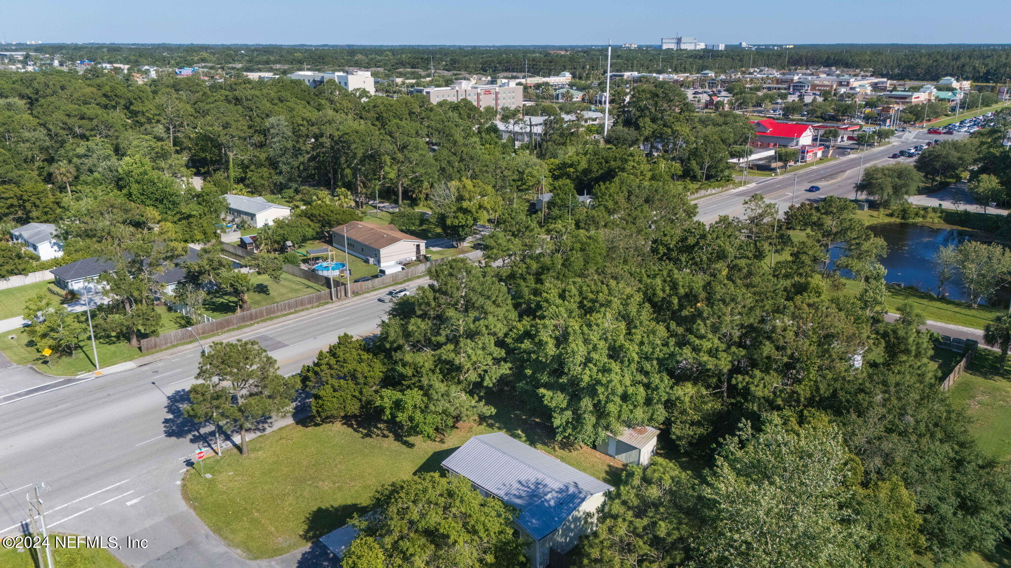 13548 Chauny Road Jacksonville, FL 32246 - Photo 41 of 55 an aerial view of a house with a yard and lake view
