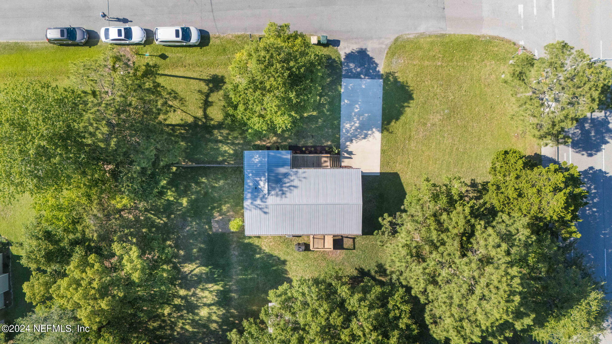 13548 Chauny Road Jacksonville, FL 32246 - Photo 46 of 55 an aerial view of a house with swimming pool and large trees