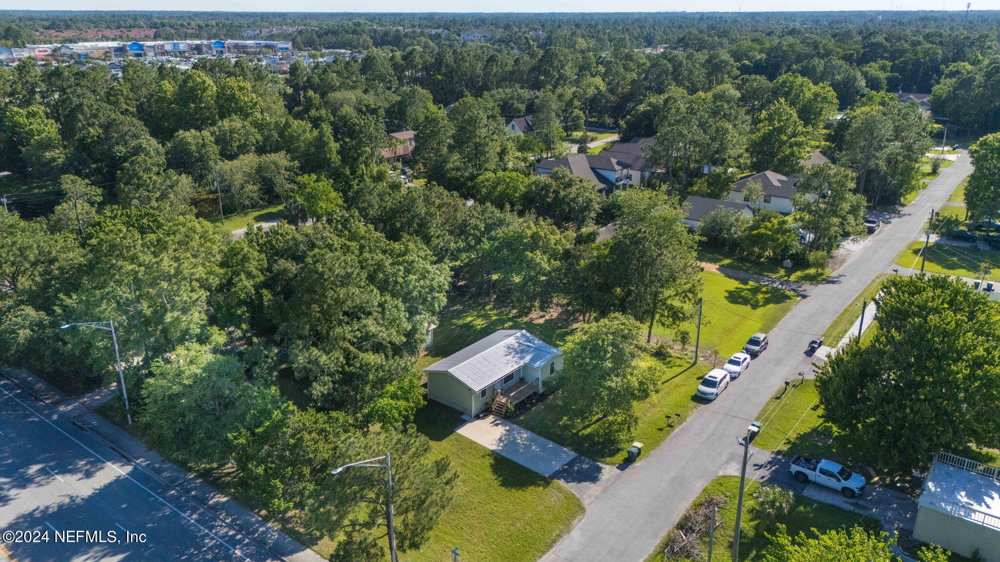 13548 Chauny Road Jacksonville, FL 32246 - Photo 49 of 55 an aerial view of a residential apartment building with a yard and parking spaces