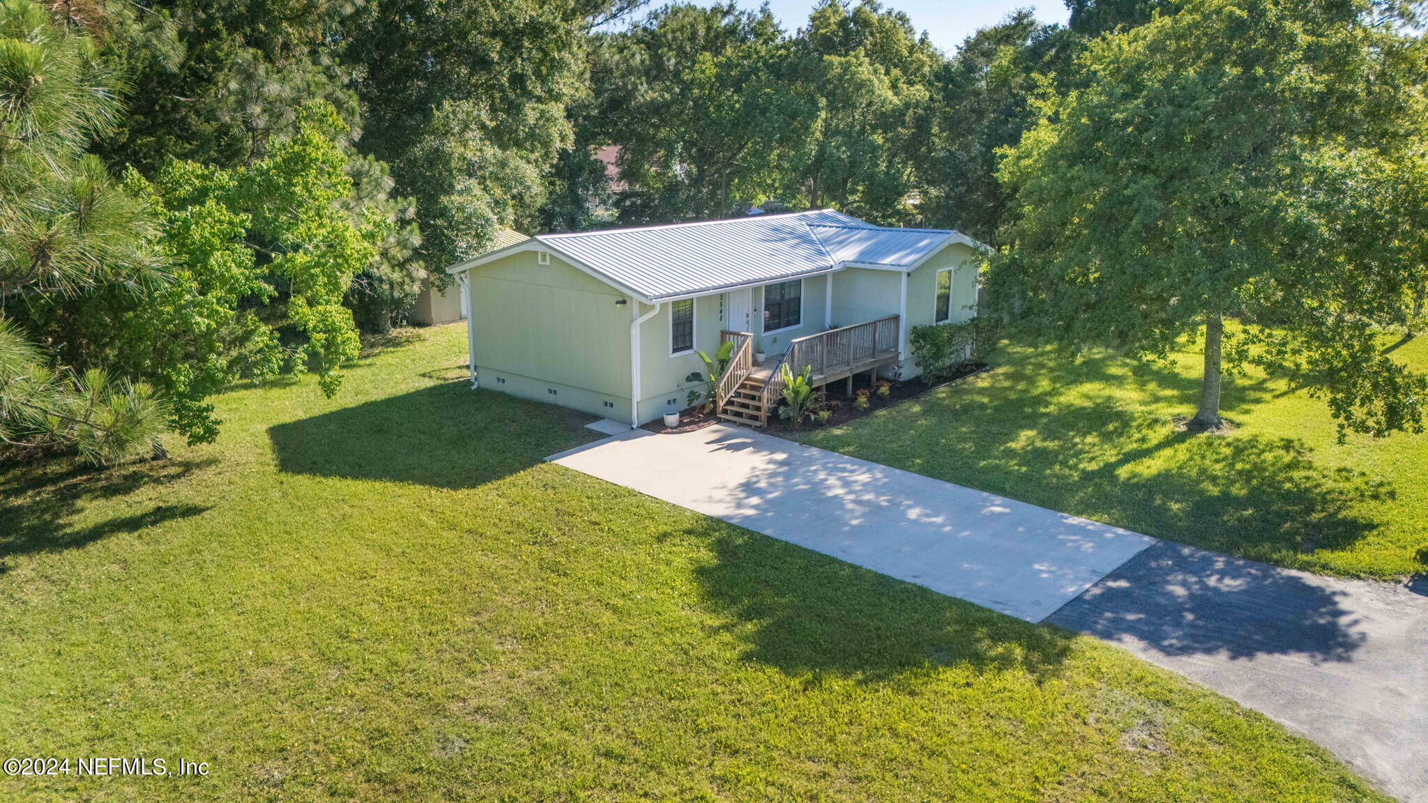 13548 Chauny Road Jacksonville, FL 32246 - Photo 51 of 55 a backyard of a house with yard and outdoor seating