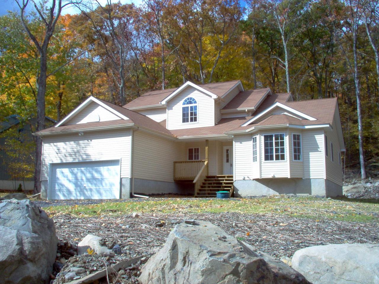 208 Decker Road Bushkill, PA 18324 - Photo 1 of 1 a front view of a house with garden