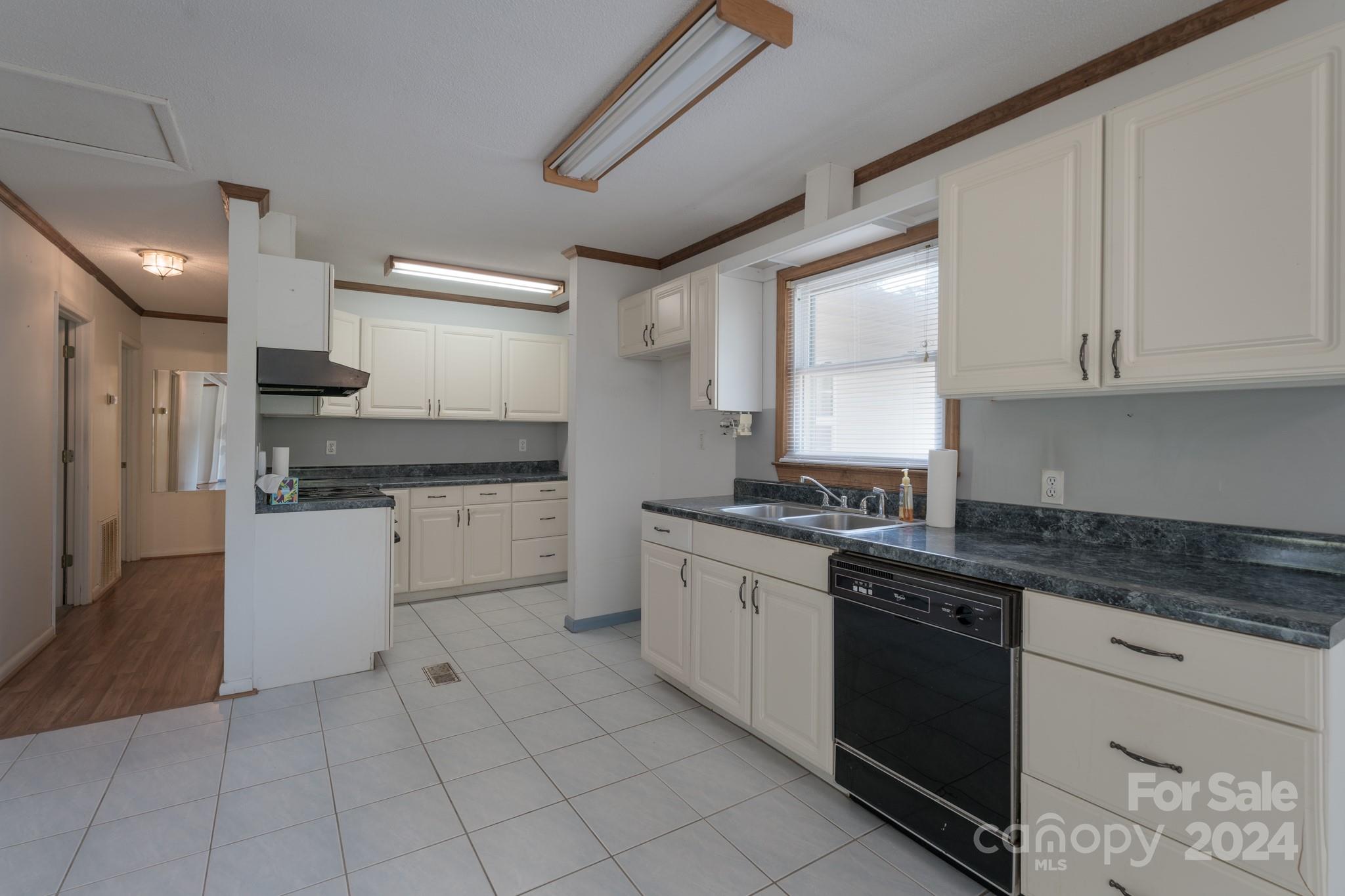 3064 Armenia Road Chester, SC 29706 - Photo 5 of 19 a kitchen with a sink dishwasher a stove and white cabinets