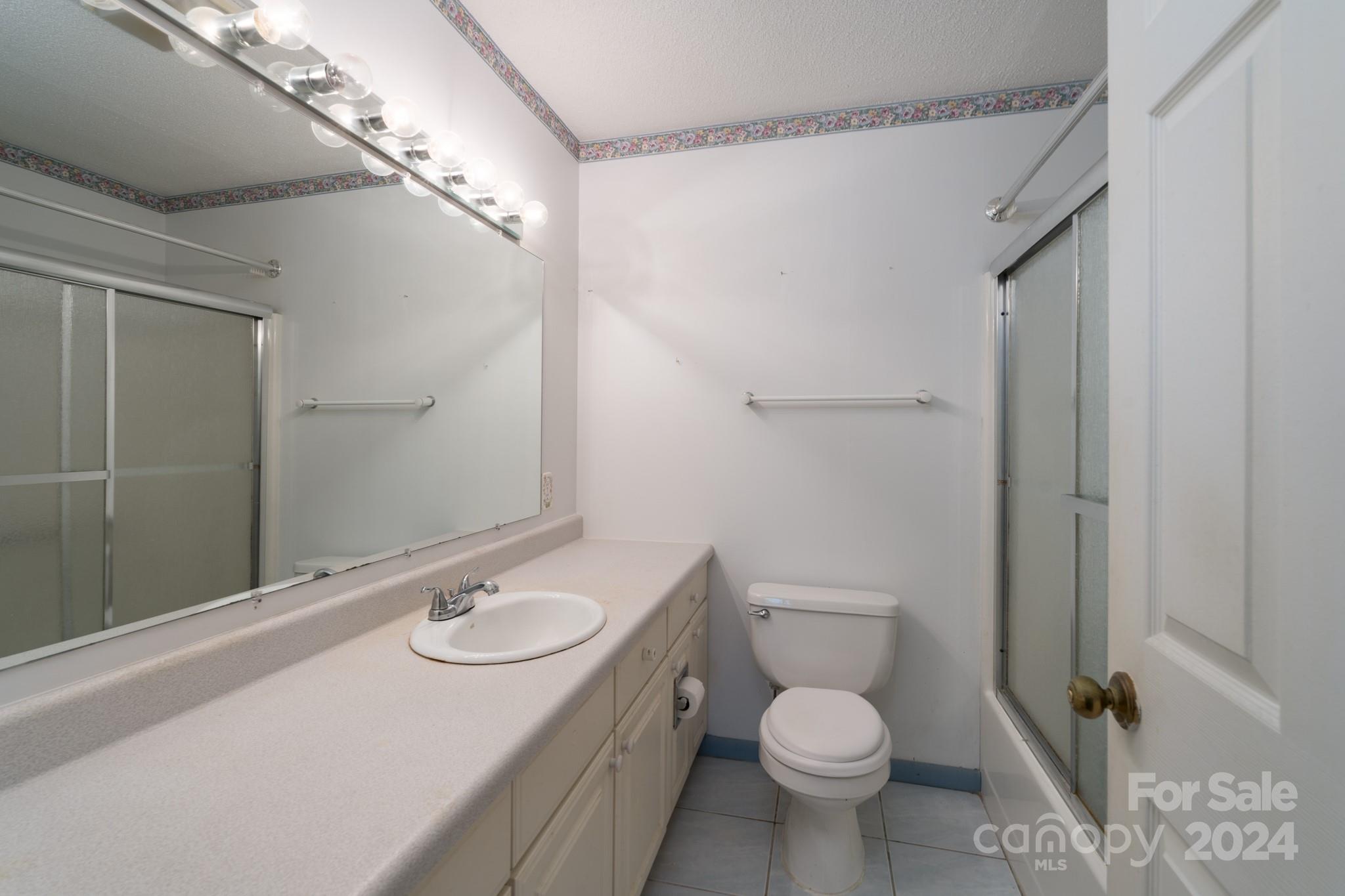 3064 Armenia Road Chester, SC 29706 - Photo 10 of 19 a bathroom with a granite countertop sink toilet and shower