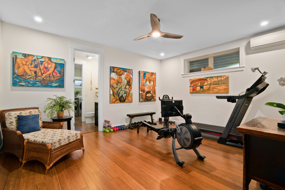 3275 Kalihiwai Road, Unit A & B Princeville, HI 96722 - Photo 21 of 30 a living room with furniture gym equipment and a flat screen tv