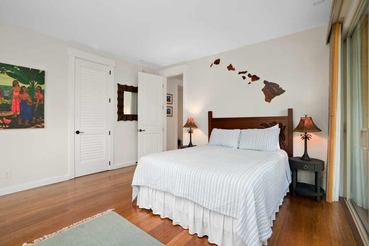 3275 Kalihiwai Road, Unit A & B Princeville, HI 96722 - Photo 22 of 30 a bedroom with a bed and a painting on the wall