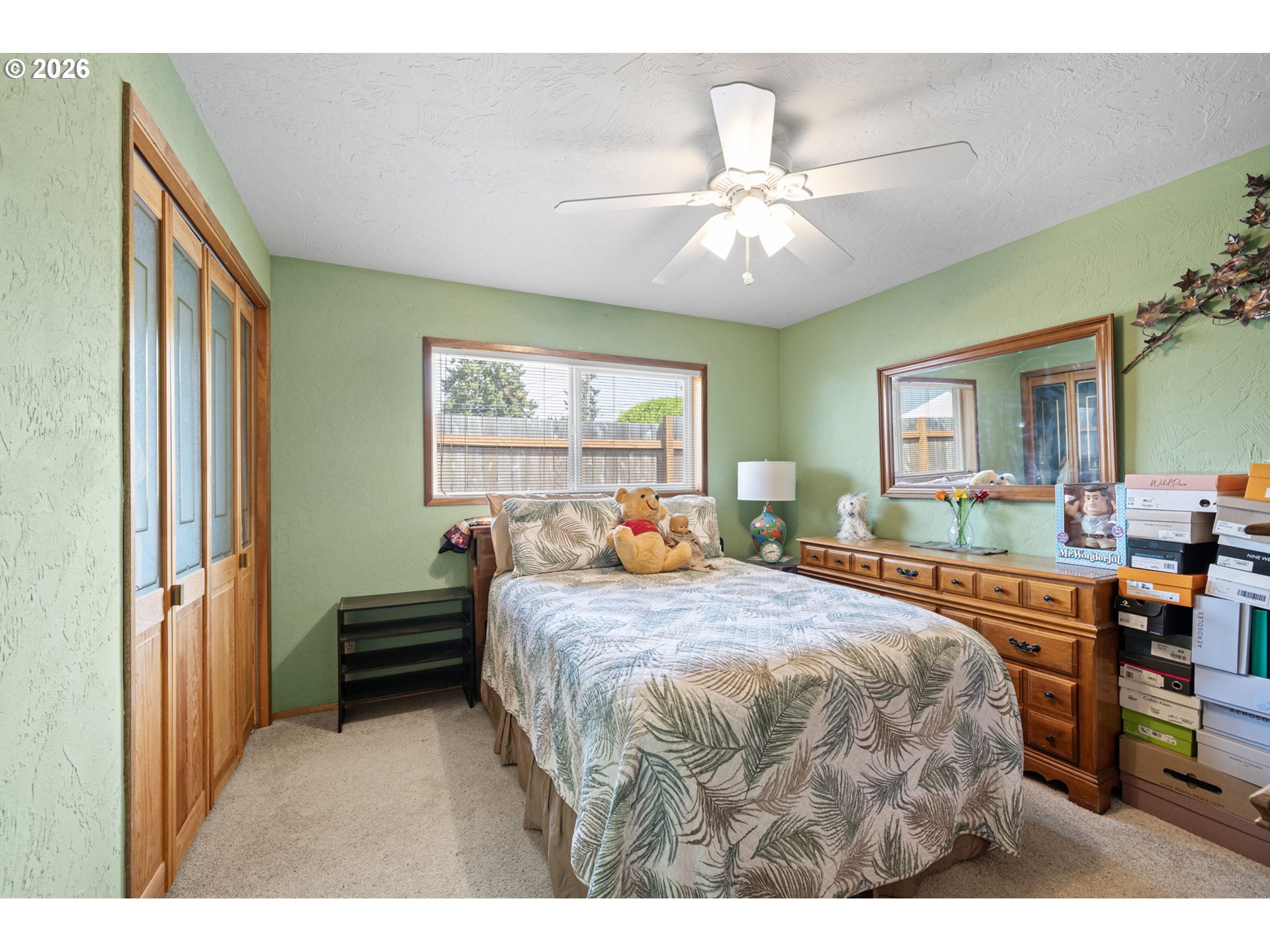 2465 17th Street Springfield, OR 97477 - Photo 28 of 47 a bedroom with a bed and a large mirror with window
