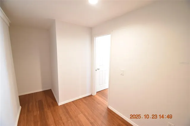 a view of hallway with wooden floor
