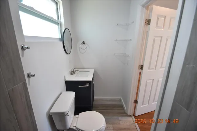 a view of kitchen with a sink refrigerator and window