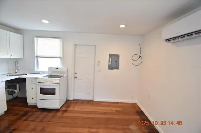 a view of empty room with a kitchen and a sink
