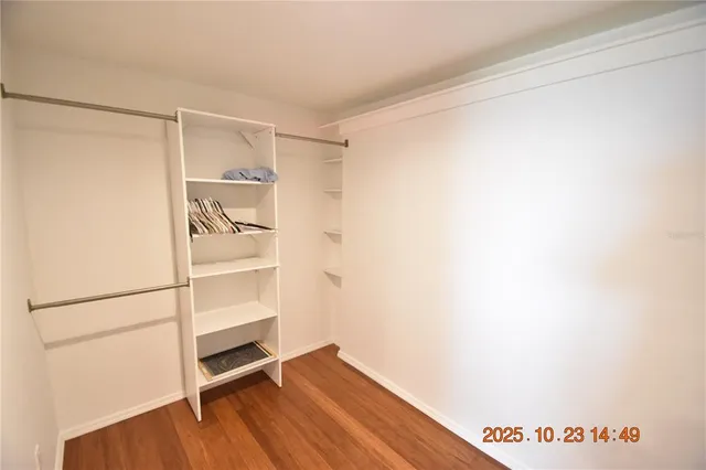 a view of walk in closet with empty racks