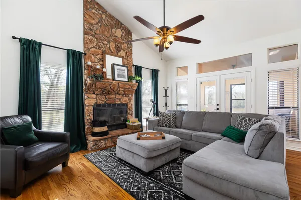 a living room with furniture and wooden floor