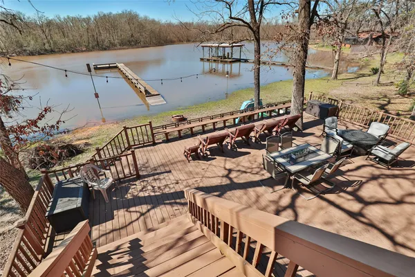 an aerial view of ocean and residential houses with outdoor space