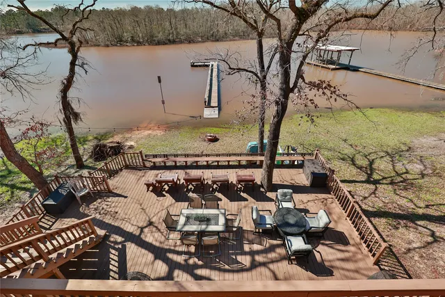 a view of swimming pool with seating area and trees around