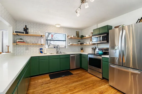 a kitchen with sink and cabinets