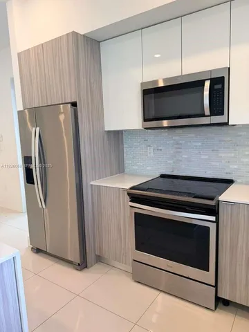 a kitchen with stainless steel appliances granite countertop a stove and a refrigerator