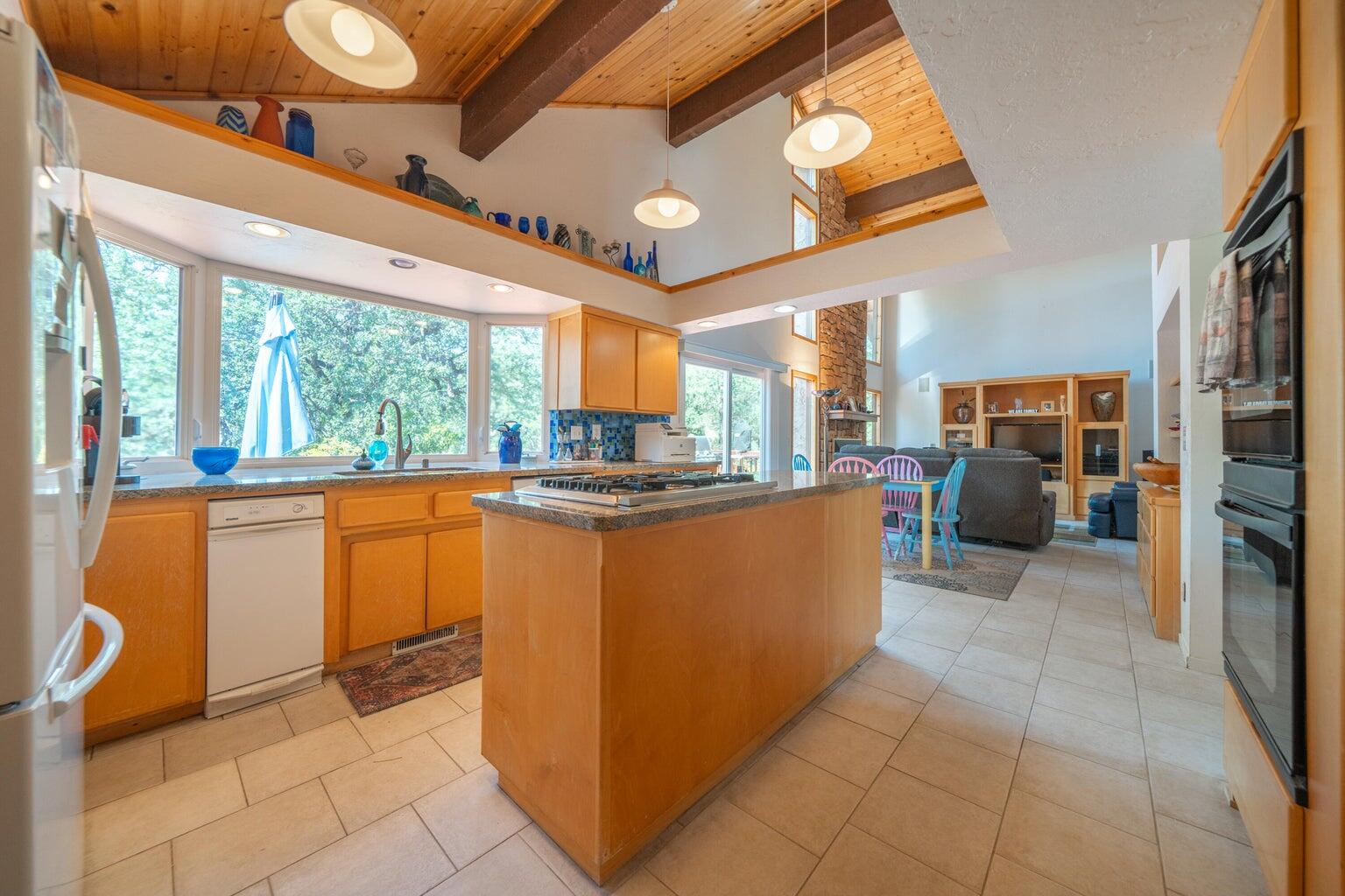 8846 Goldstone Lane Redding, CA 96001 - Photo 19 of 64 a kitchen with stainless steel appliances granite countertop a refrigerator and a stove