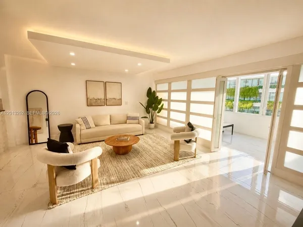 a living room with furniture and a large window