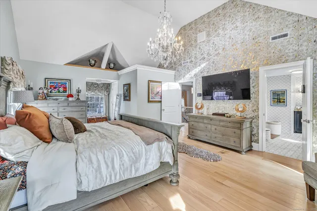 a bedroom with a bed and flat screen tv