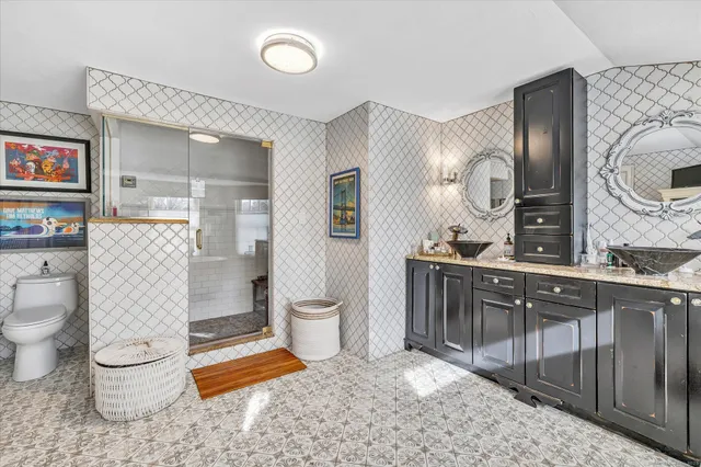 a spacious bathroom with a toilet sink and mirror
