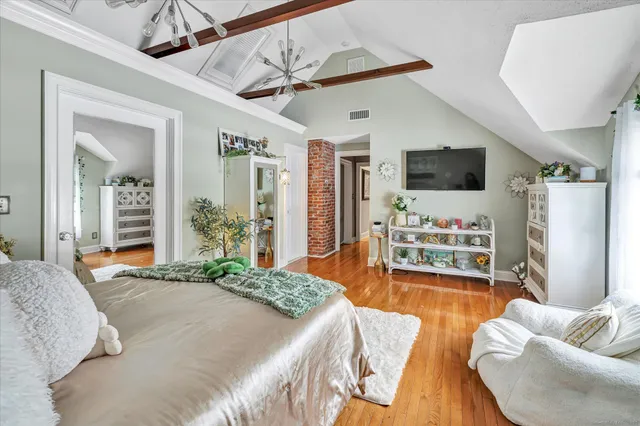 a bedroom with furniture and a flat screen tv