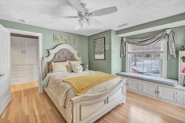 a bedroom with a large bed and a chandelier