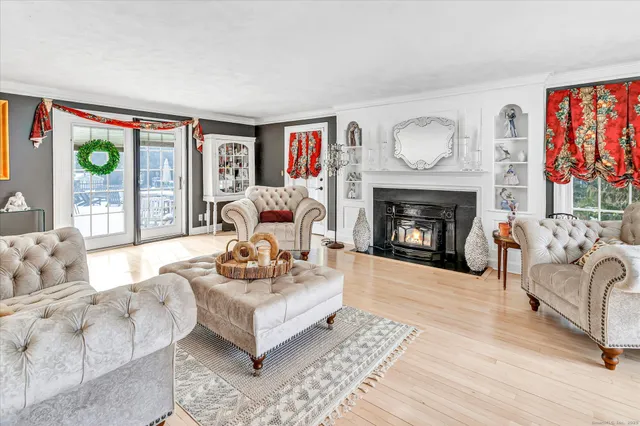 a living room with furniture large window and a fireplace