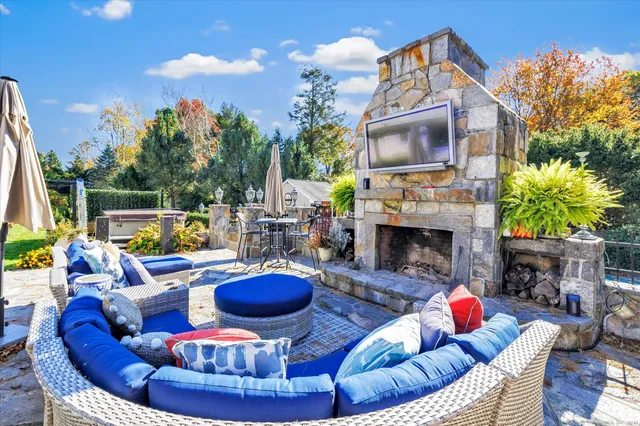 a living room with furniture a fireplace and a flat screen tv