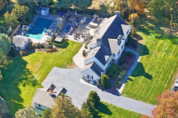 an aerial view of a house with a garden and swimming pool