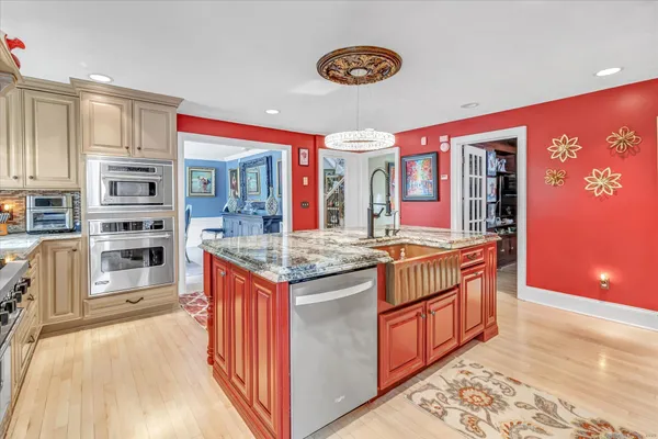 a kitchen with stainless steel appliances granite countertop a stove and cabinets