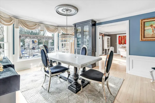 a view of a dining room with furniture window and wooden floor