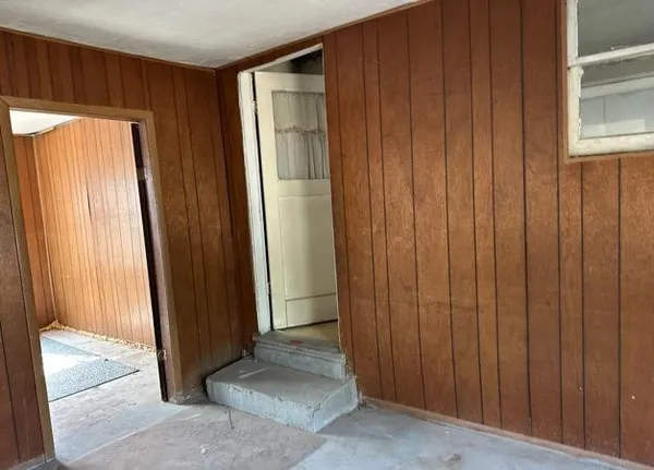 an empty room with large windows