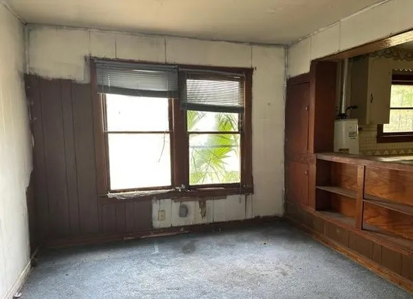 a kitchen with a stove sink and cabinets