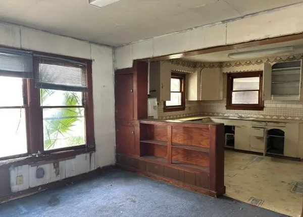 a view of a kitchen with a sink dishwasher and fireplace