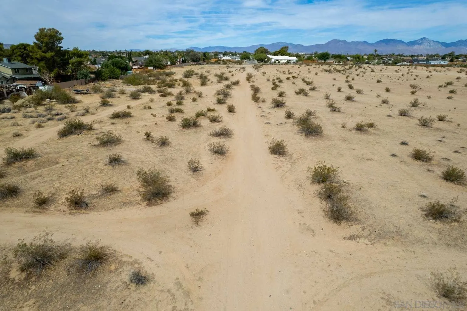 0 West Perch Avenue, Unit 15 Ridgecrest, CA 93555 - Photo 22 of 40 a view of a dry yard covered with snow in the background