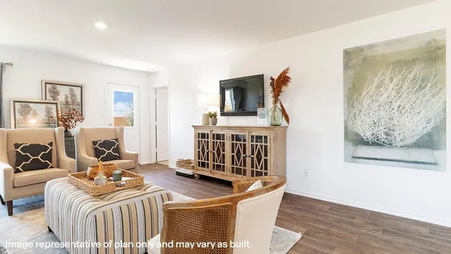 a living room with furniture a flat screen tv and a table