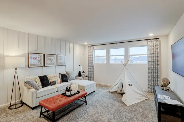 a bedroom with furniture and a large window