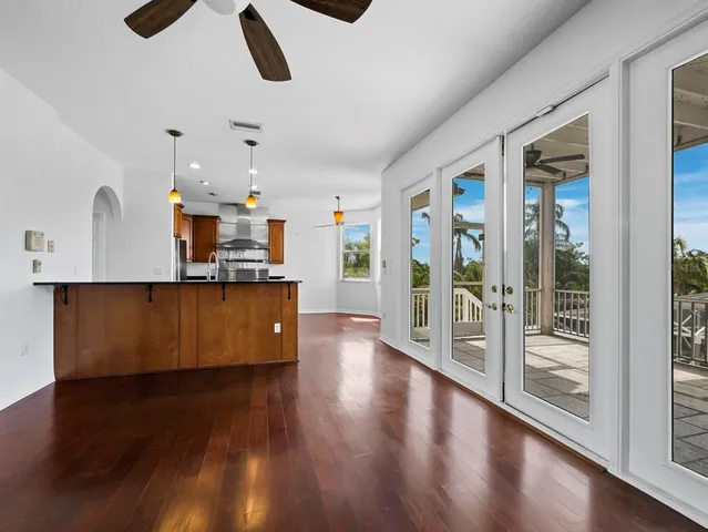 a kitchen with stainless steel appliances granite countertop a stove and a wooden floors