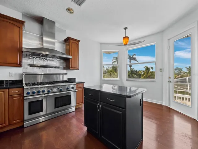 a kitchen with stainless steel appliances granite countertop a stove and a microwave