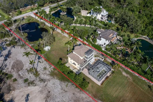 a view of a house with a big yard and large trees