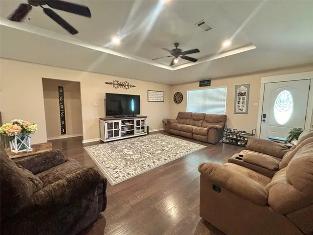 a living room with furniture ceiling fan and a rug
