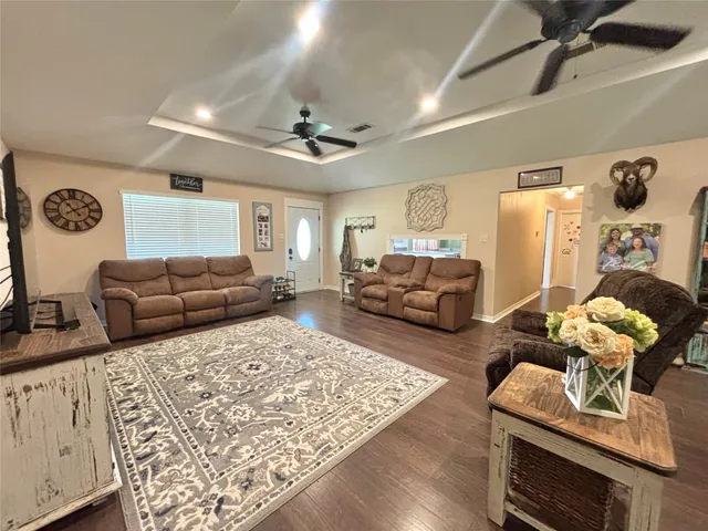 a living room with furniture a couch and a window
