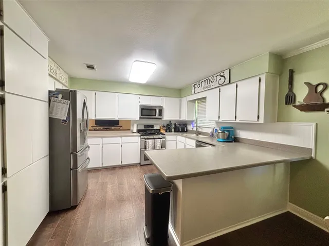 a kitchen with a refrigerator stove and microwave