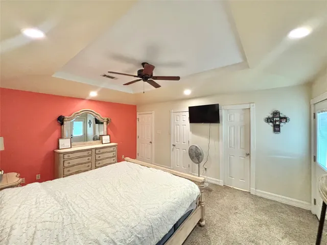 a spacious bathroom with a double vanity sink a toilet and a mirror