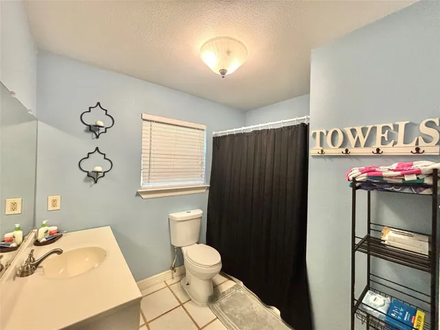 a room with gym equipment and wooden floor