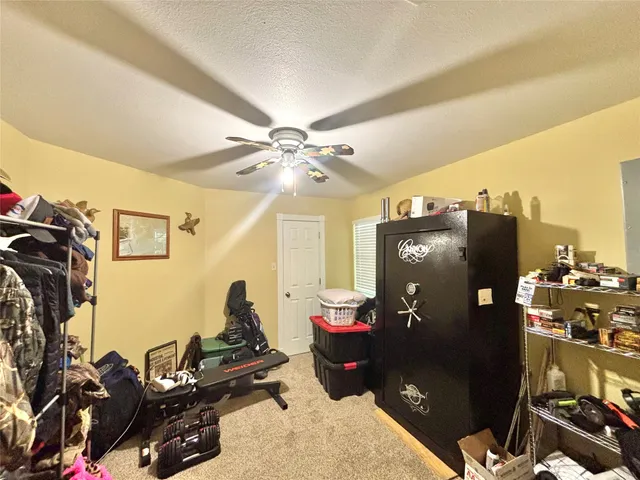 a bedroom with a bed and a mirror on a dresser