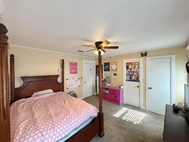 a bedroom with a bed dresser and a window