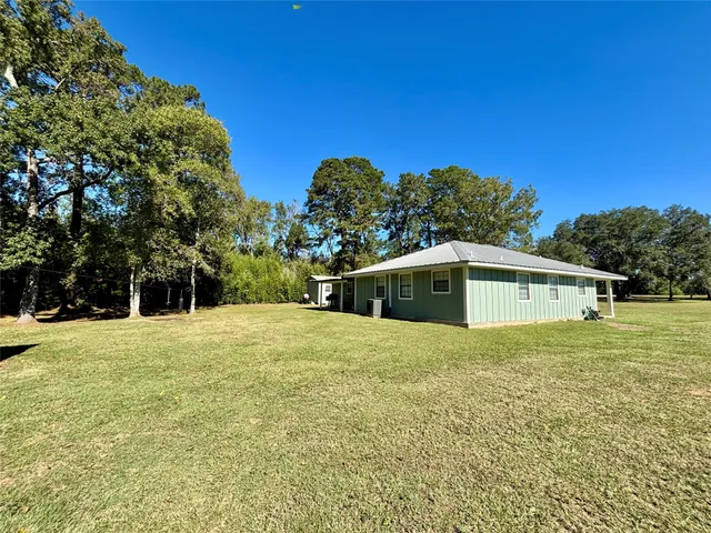 a view of a backyard with large trees