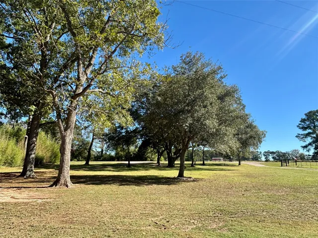 a view of a swimming pool with trees and a lake