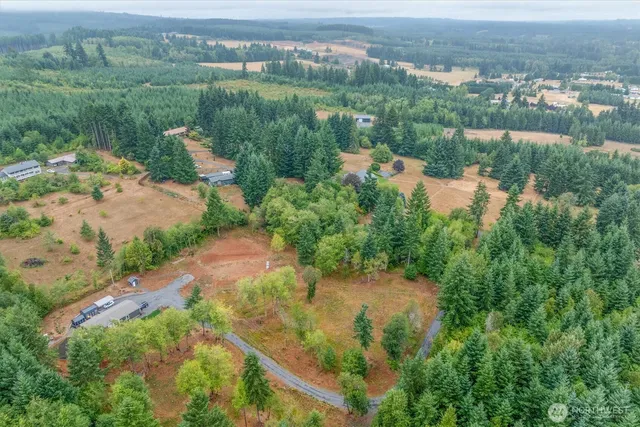 an aerial view of lake residential house with outdoor space and trees all around